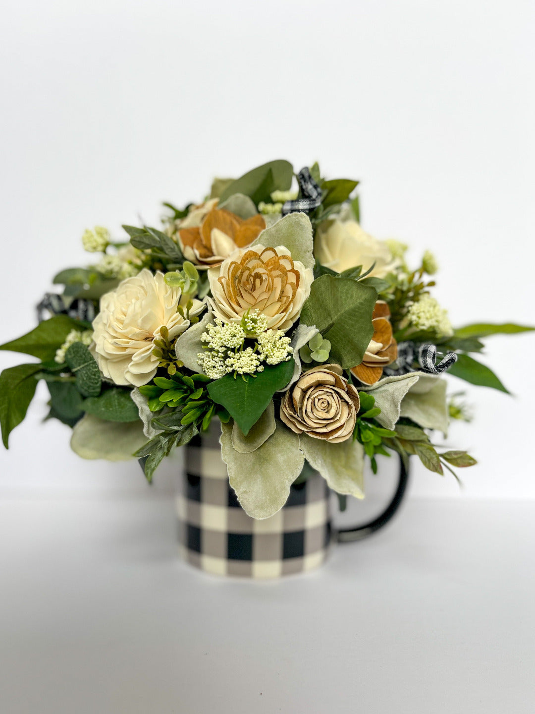 Large navy and white plaid mug paired with ivory and greenery wooden floral bouquet.