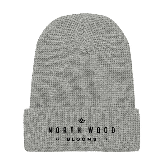 Light grey waffle beanie with "North Wood Blooms" written in black print.