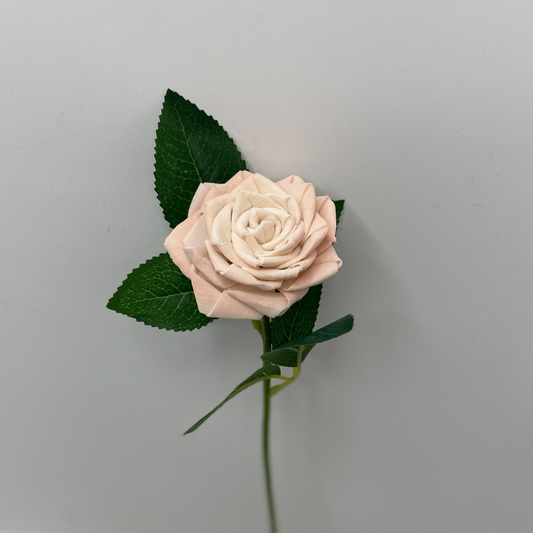 Single stem wooden woven rose with green leaves.