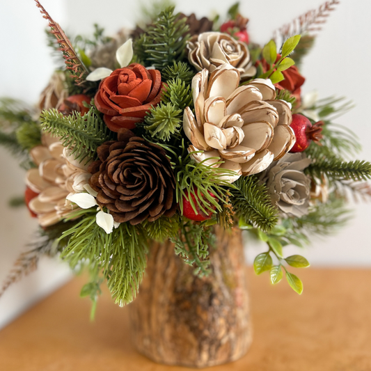 Fall bouquet with wooden handcrafted flowers, green pine needles, and pinecones. 