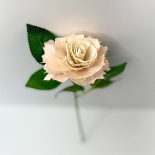 Single stem wooden ruffled rose with green leaves.