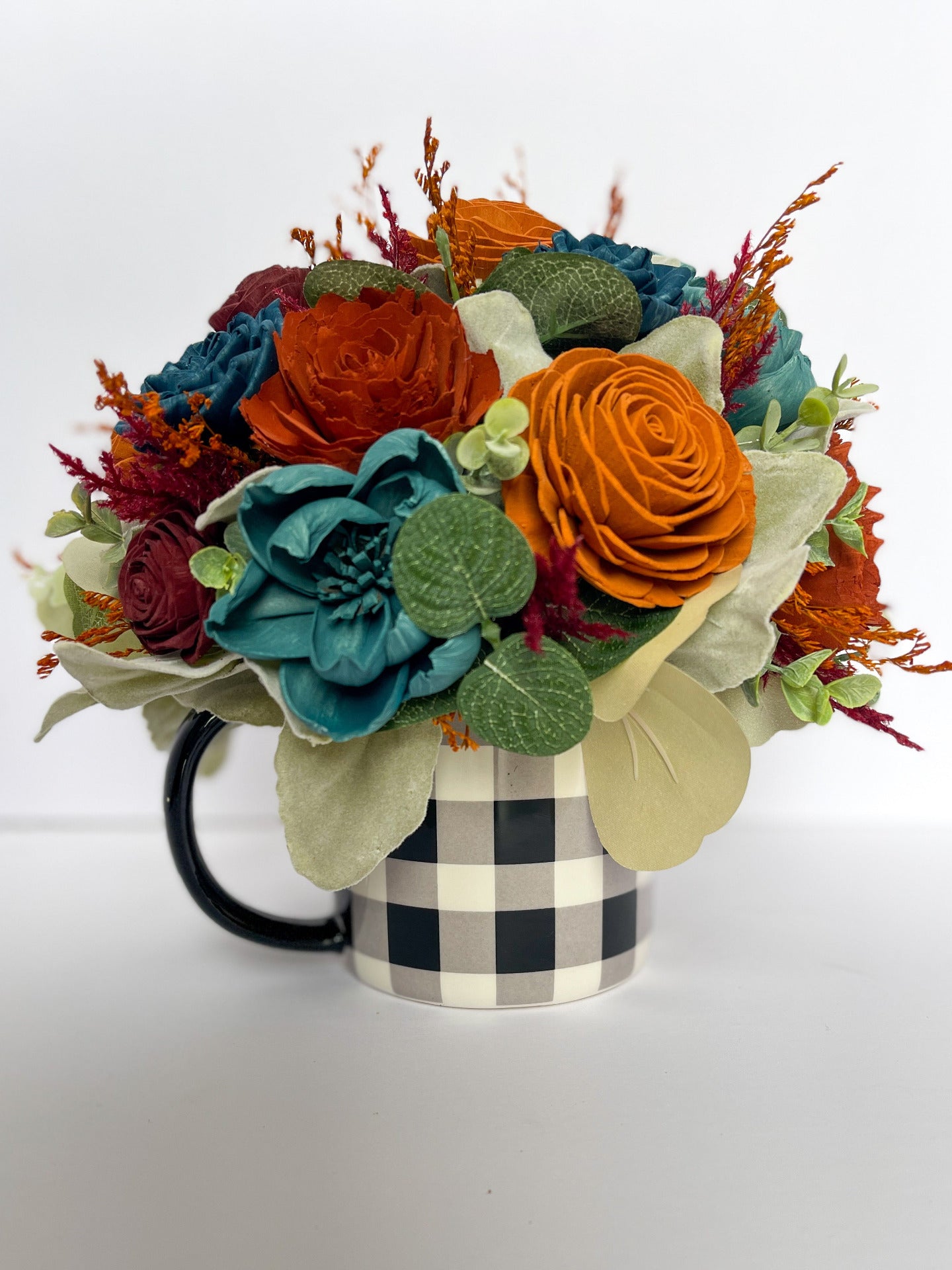 White and navy buffalo Paid Mug with handcrafted green, orange, and blue wood flower bouquet.