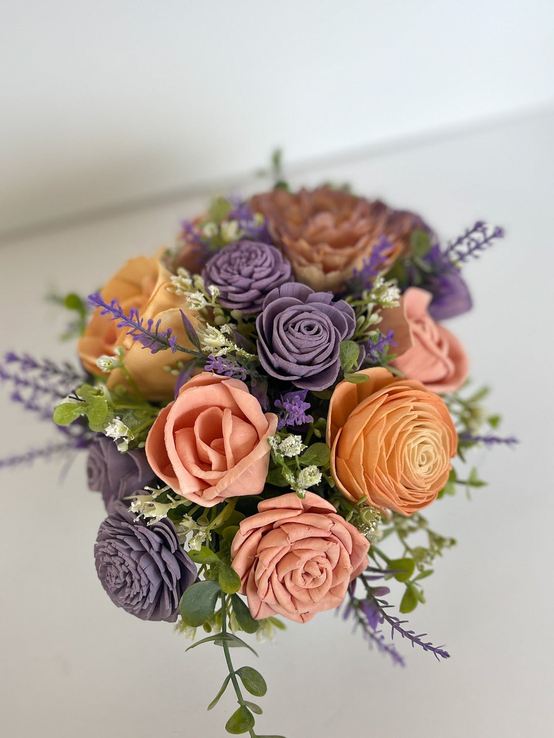 Pastel orange, pink & purple wooden flower bouquet with greenery within silver galvanized planter.