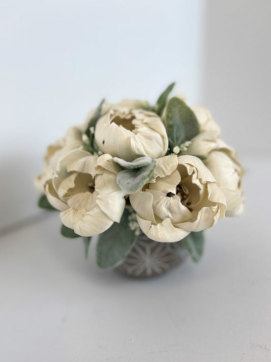 Wooden ivory floral bouquet with greenery in a matching vase.