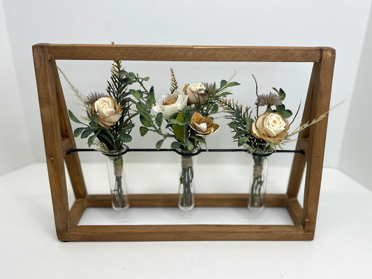 Wooden "A-frame" bouquet stand with three wood flower bouquets placed in clear vases. 