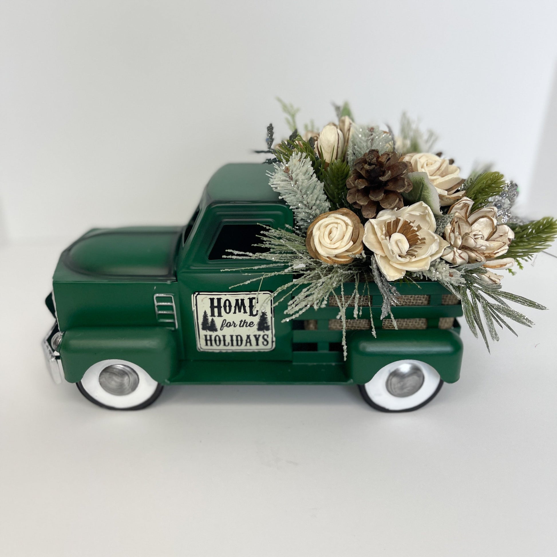 Metal holiday truck in either green, red, or white for wooden flower insert decoration.