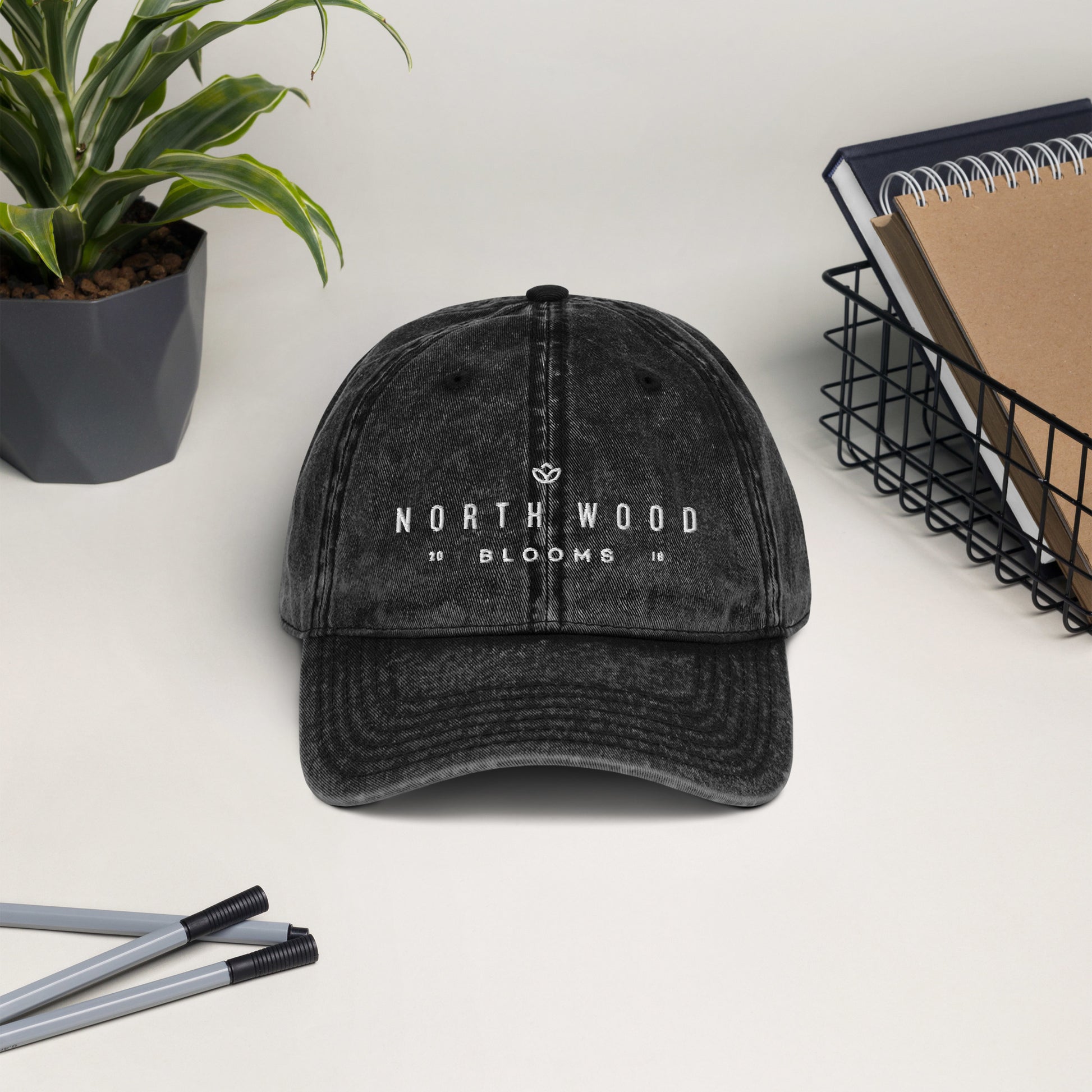 Vintage black cap with "North Wood Blooms" written in white print. 